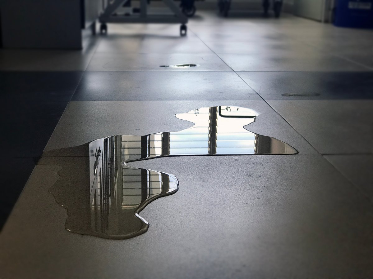 Water puddle on floor creating dangerous slip and fall accident hazard
