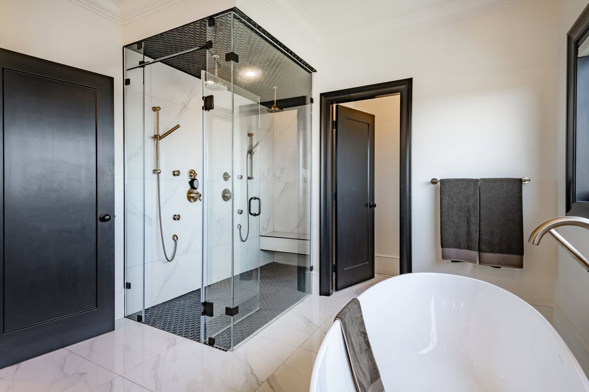 Large luxury bathroom with tiled walls and floors restored to a uniform finish