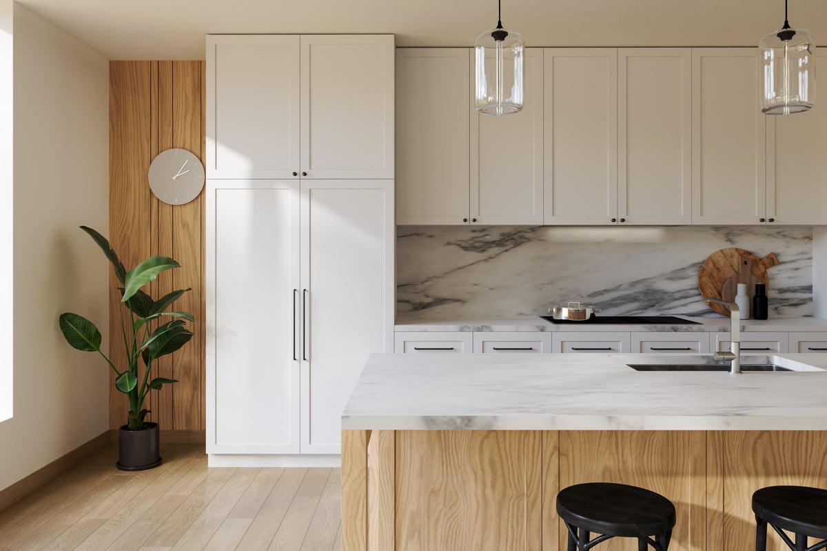 Close-up of empty modern kitchen with white cabinets and marble island, backsplash.